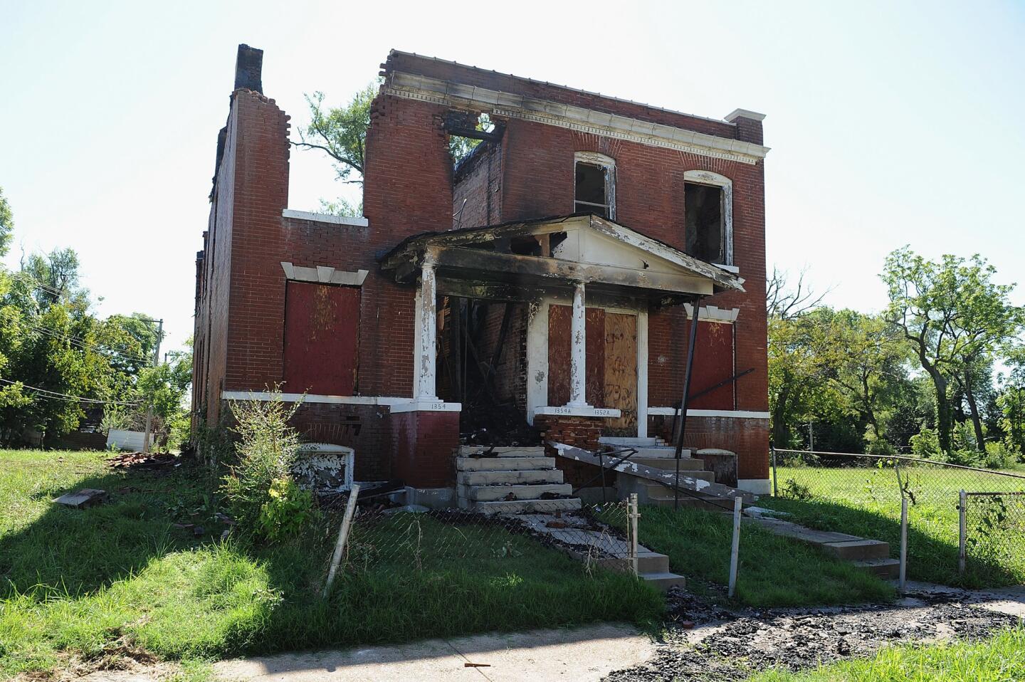 An uninhabited house set ablaze by protesters is seen Aug. 20, 2015, in St. Louis.