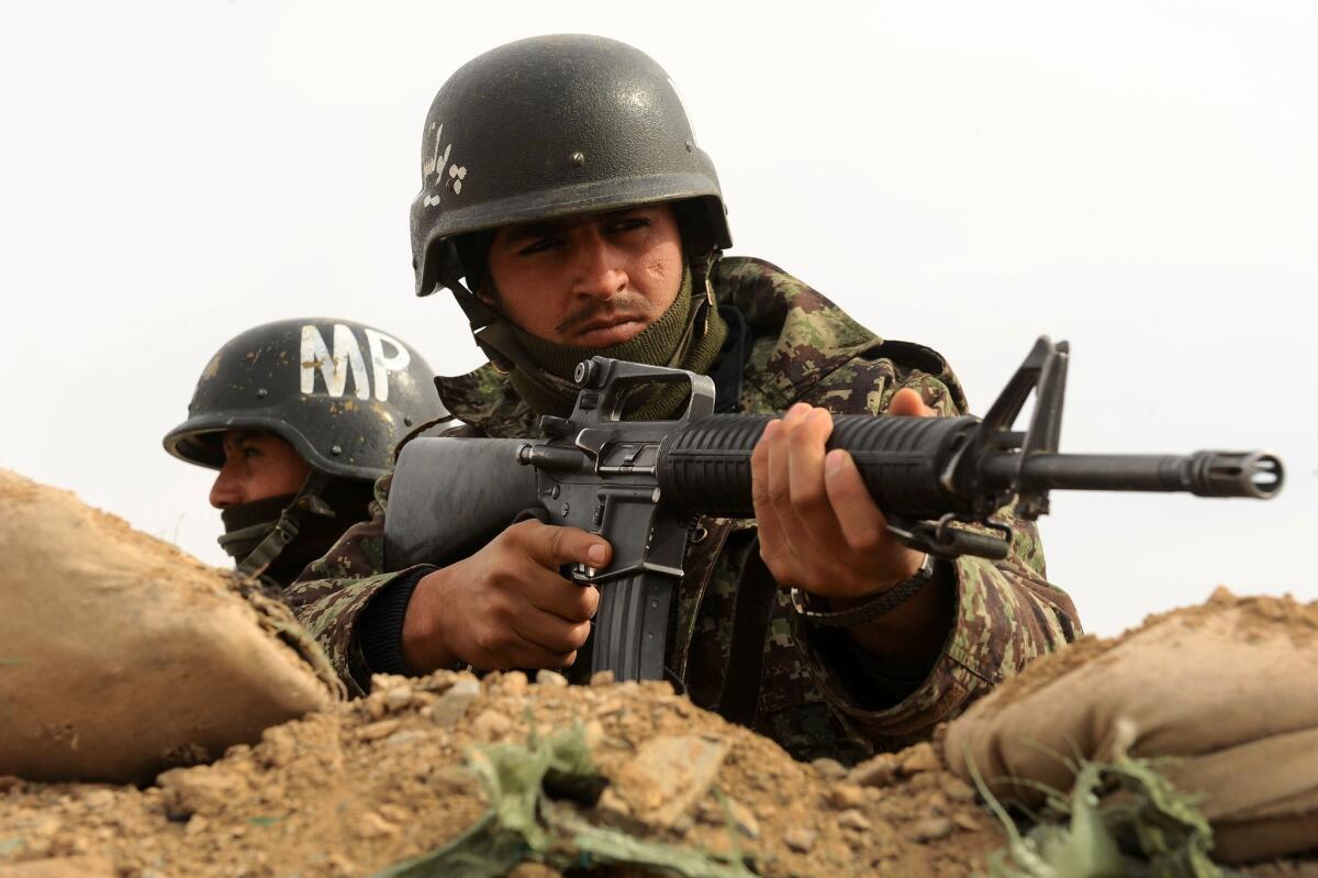 Afghan soldiers patrol an area near Herat.