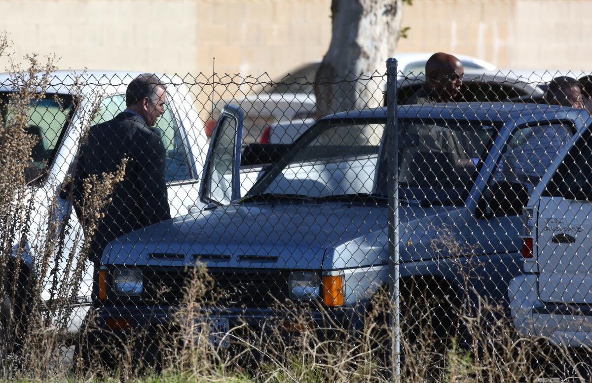 Investigators examine a pickup truck where the body of a baby girl was found Saturday in Santa Clarita.