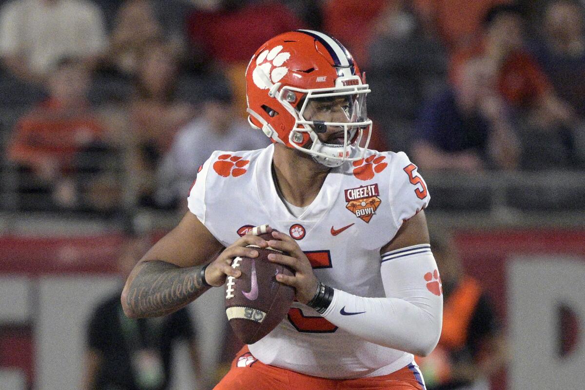FILE - Clemson quarterback D.J. Uiagalelei (5) looks for a receiver during the second half of the Cheez-It Bowl NCAA college football game against Iowa State, Wednesday, Dec. 29, 2021, in Orlando, Fla. Veteran quarterbacks are plentiful in the Atlantic Coast Conference this season. In all, 12 of the 14 league teams have at least one quarterback with nine or more career starts. (AP Photo/Phelan M. Ebenhack, File)