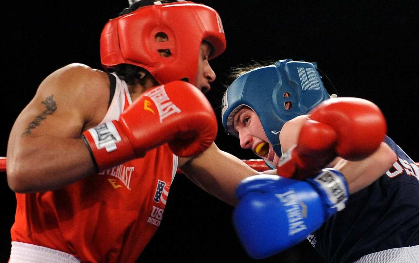 Queen Underwood, left, and Mikaela Mayer work inside against each other during their women's lightweight division final at the U.S. Olympic boxing trials in Airway Heights, Wash., on Saturday night.