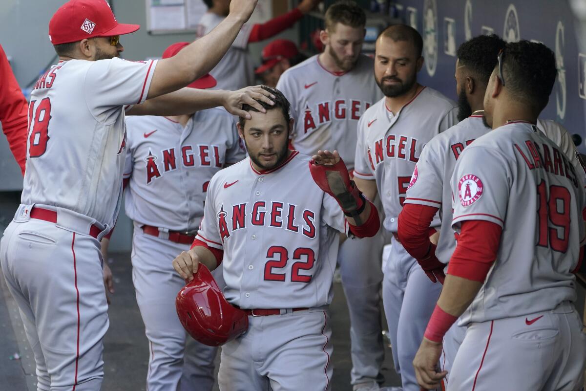 Los Angeles Angels' Jared Walsh reacts after he hit a two-run home run that  scored Phil Gosselin during the fourth inning of a baseball game against  the Seattle Mariners, Sunday, Oct. 3