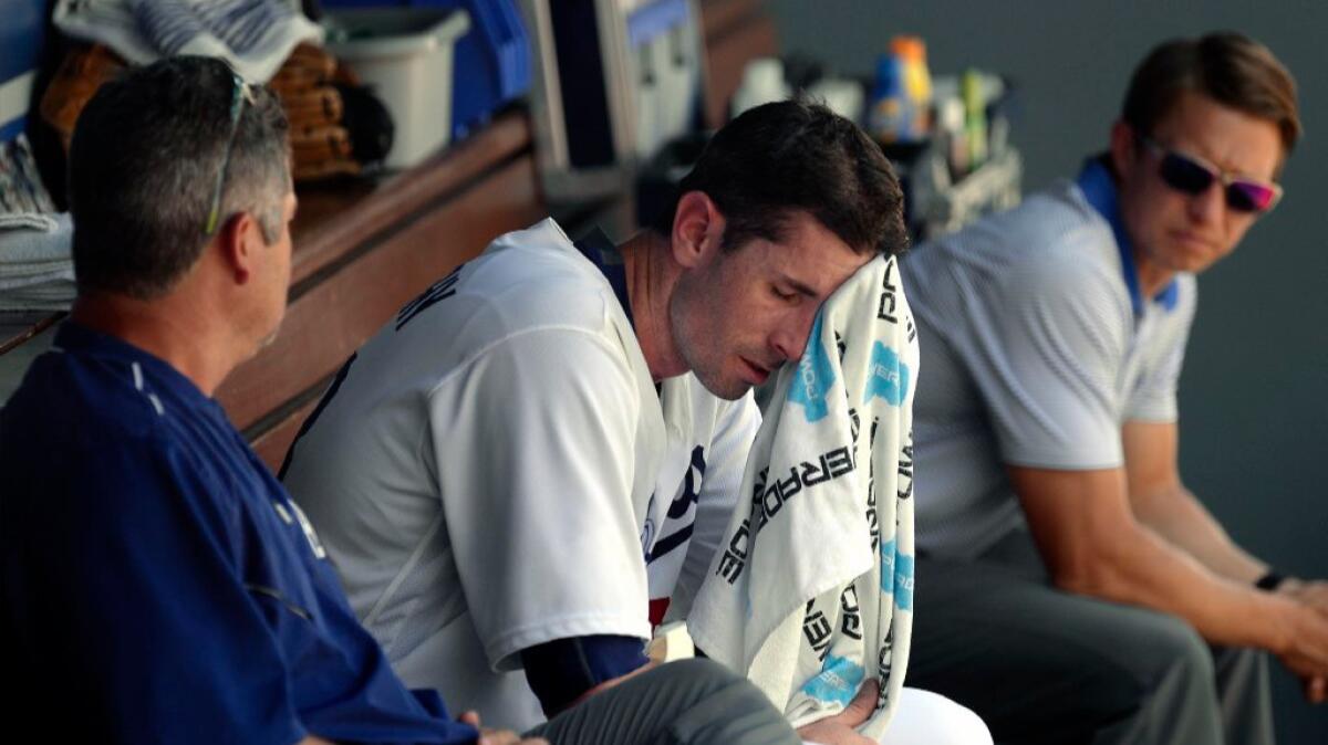 Dodgers pitcher Brandon McCarthy wipes the sweat from his face after getting taken out of the game with an injury.