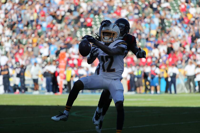 CARSON, CA - SEPTEMBER 22, 2019: Los Angeles Chargers wide receiver Travis Benjamin (12) can't hang onto a pass with Houston Texans free safety Tashaun Gipson (39) defending with less then 2 minutes left in the game at Dignity Health Sports Park on September 22, 2019 in Carson, California. Texans won 27-20.(Gina Ferazzi/Los AngelesTimes)