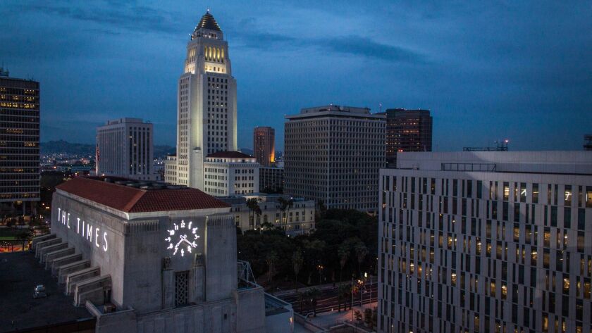 Los Angeles City Hall, center. The City Council voted 13-0 to pay a former aide who, a judge ruled, was wrongfully arrested.