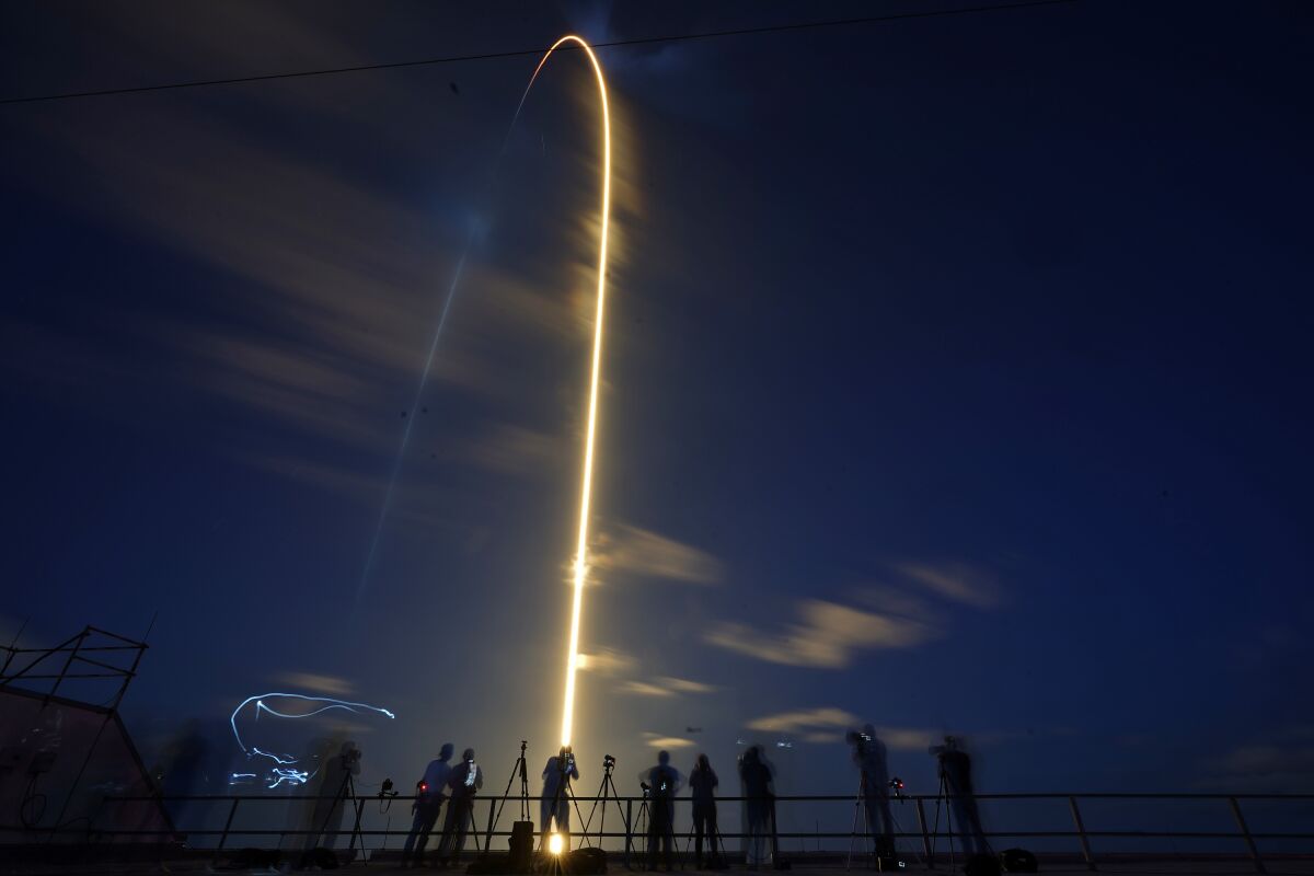 A SpaceX Falcon 9 rocket, with four private citizens onboard, lifts off in this time-exposure photo from Kennedy Space Center's Launch Pad 39-A, Wednesday, Sept. 15, 2021, in Cape Canaveral, Fla. (AP Photo/John Raoux)