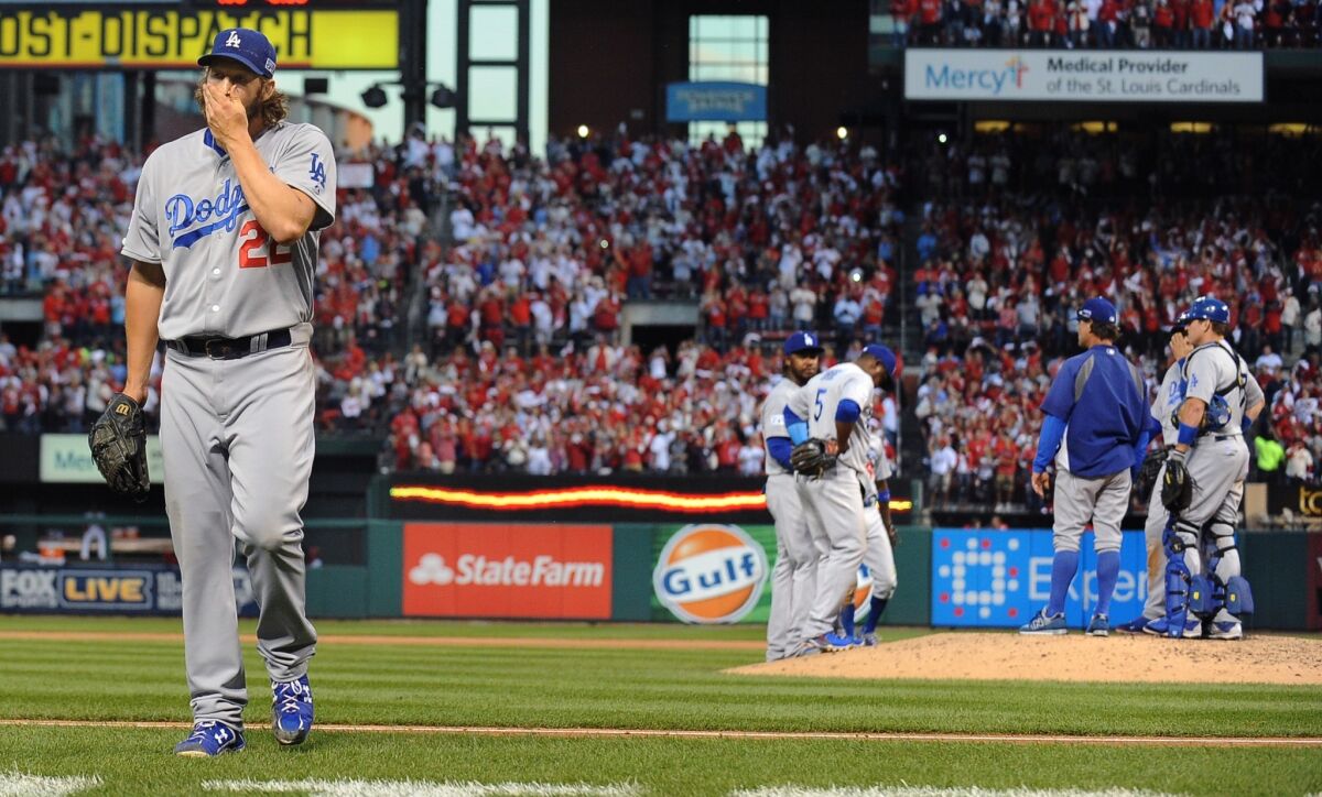 Clayton Kershaw heads to the Dodgers' dugout after giving up a three-run home run to St. Louis first baseman Matt Adams in the seventh inning of Game 4 of the National League Division Series.
