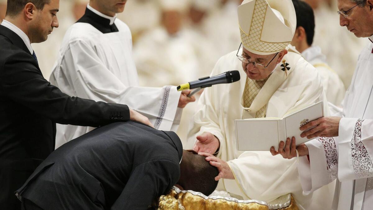 Pope Francis baptizes John Francesco Ogah during an Easter Vigil ceremony March 31 in St. Peter's Basilica.