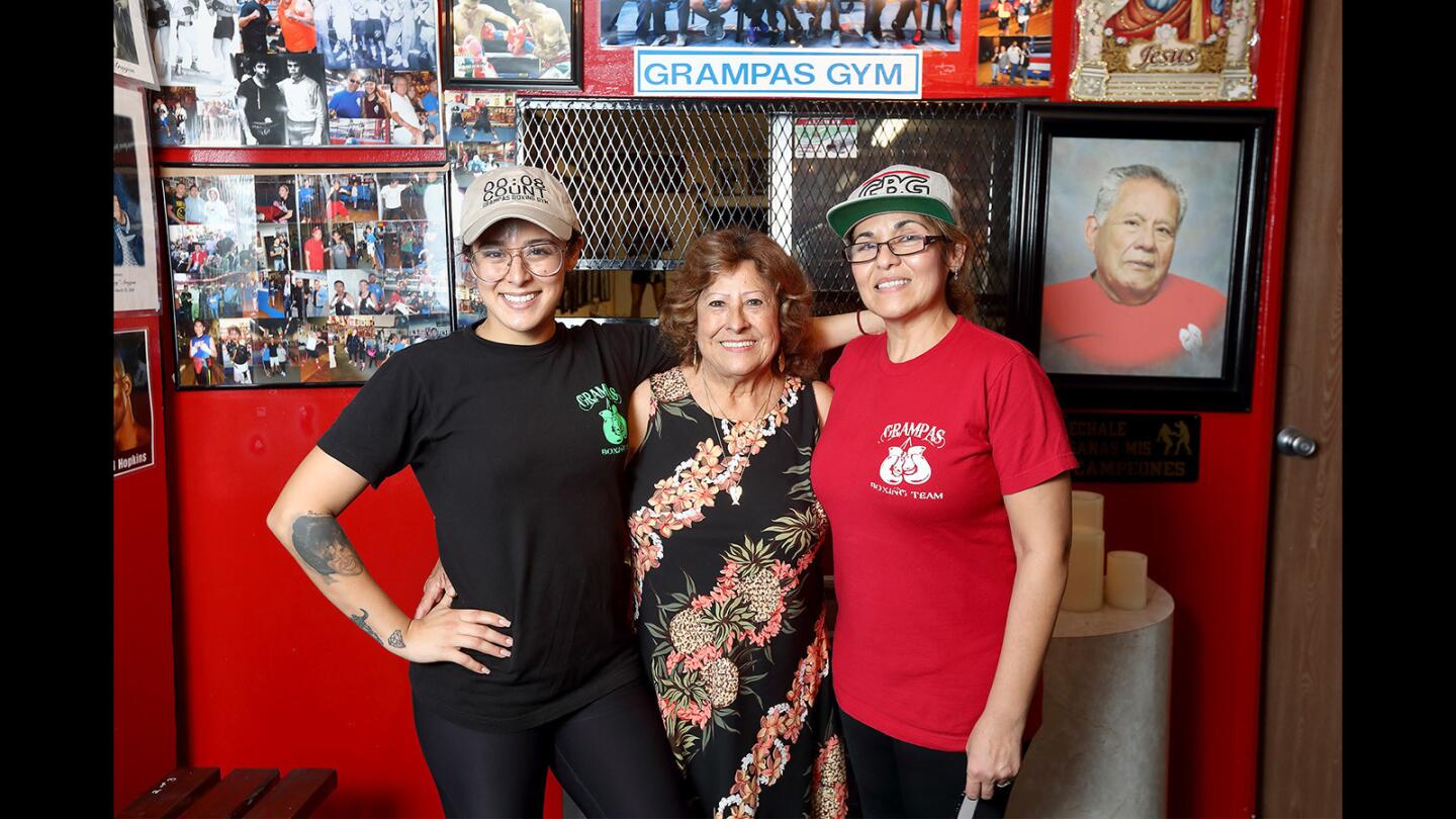 From left, Jessica Rangel, her grandmother Jessie Rangel, and her mother, Marie Rangel, run Grampas Boxing Gym in Westminster. Jessica's grandfather, Rene, introduced her to boxing at a young age. Rene "Grampa" Rangel died in May 2016; a framed picture of him hangs in the entrance way, at right.