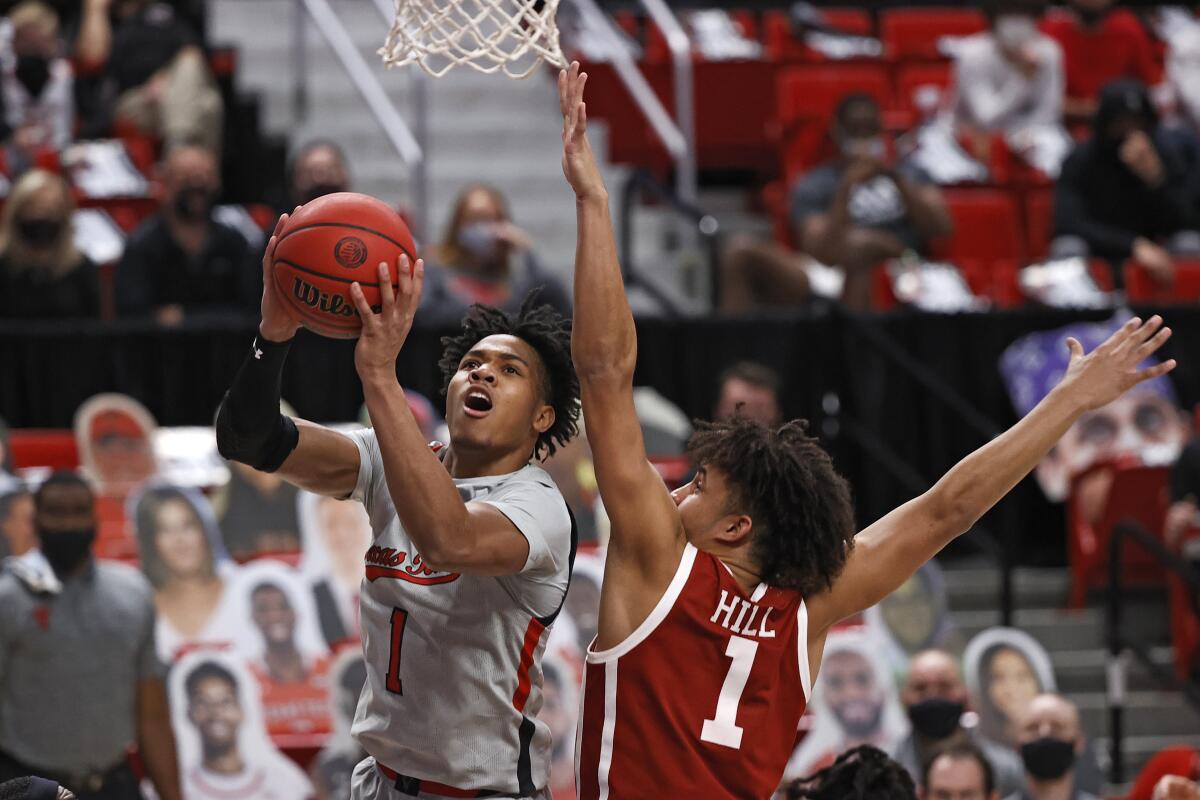 Texas Tech's Terrence Shannon Jr. lays up the ball around Oklahoma's Jalen Hill.