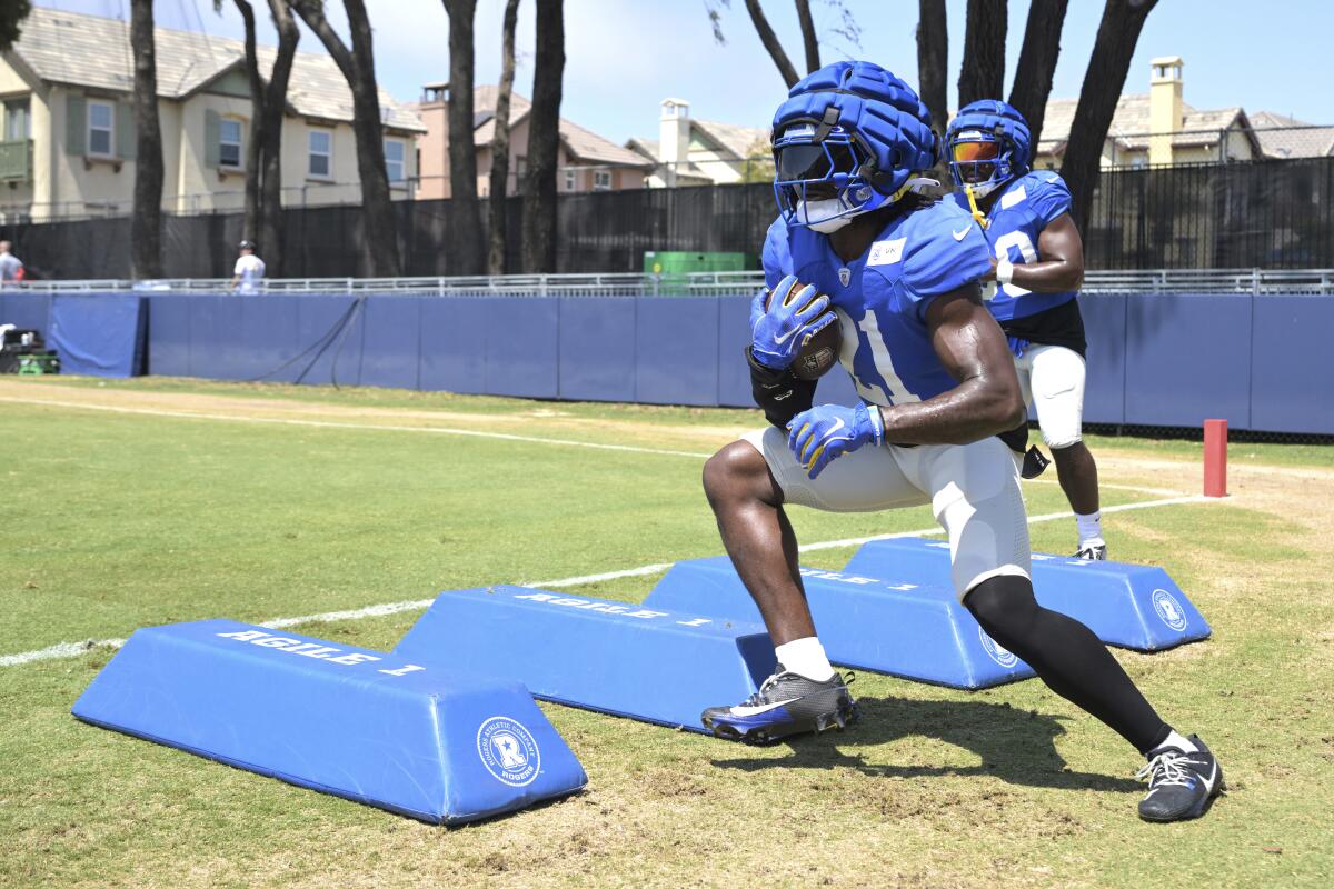 Rams running back Zach Evans (21) participates in drills during training camp.