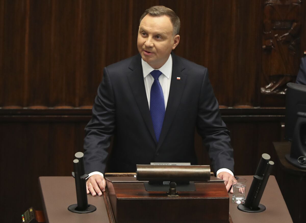 Poland's President Andrzej Duda speaks to parliament members after he had been sworn in for a second term, at the parliament, in Warsaw, Poland, on Thursday, August 6, 2020. Many of Poland's former leaders abstained from the ceremony to show disapproval for his first term policies.(AP Photo/Czarek Sokolowski)