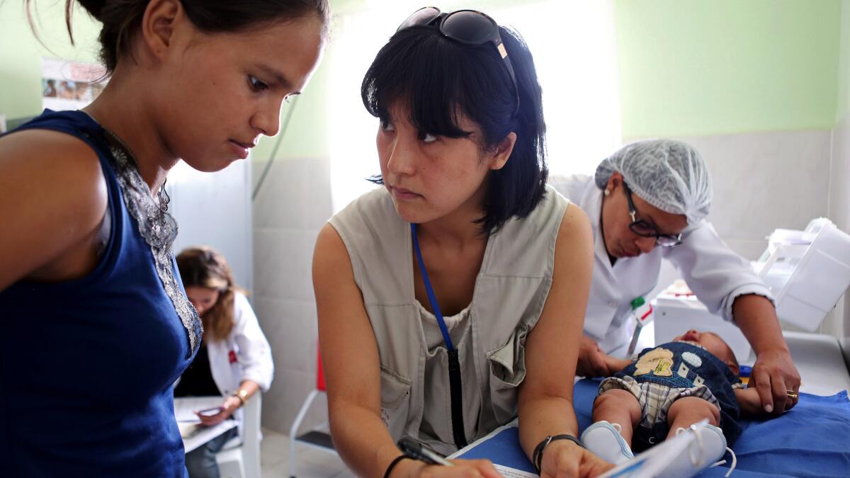 Dr. Megumi Itoh, center, an epidemic intelligence officer with the U.S. Centers for Disease Control and Prevention, helps investigate a Zika outbreak in Brazil.