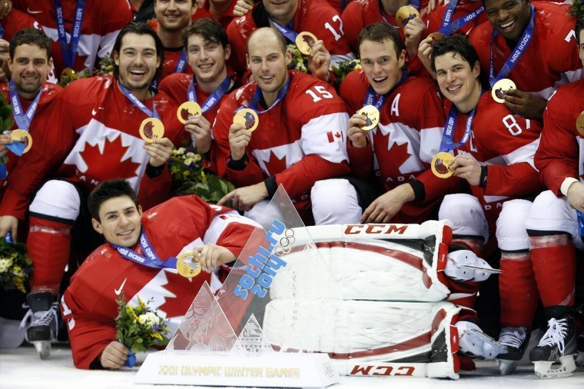 Canadian hockey players pose after winning the Olympic gold medal on Feb. 23 in Sochi, Russia.