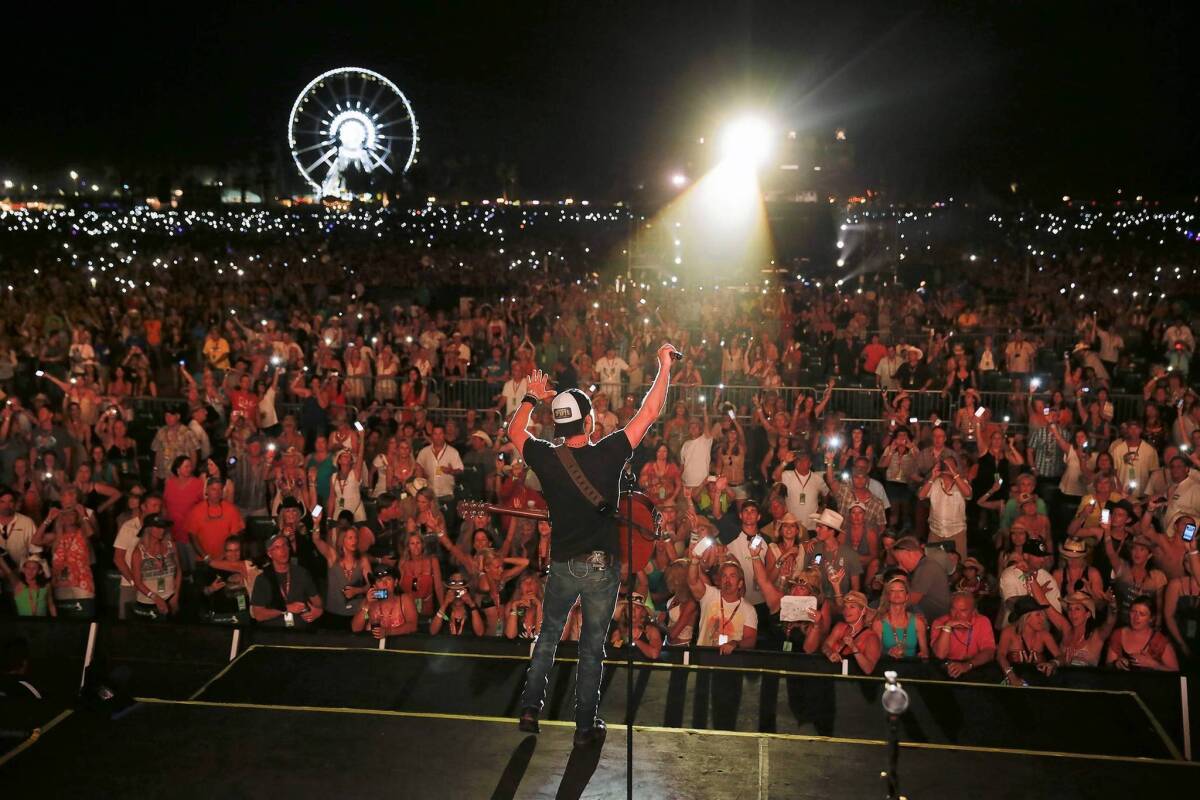 Dierks Bentley performs the song "Home" as the crowd participates by holding up its lighted-up cellphones on the Mane Stage on the second day of the Stagecoach Country Music Festival at the Empire Polo Club in Indio, on April 27, 2013.