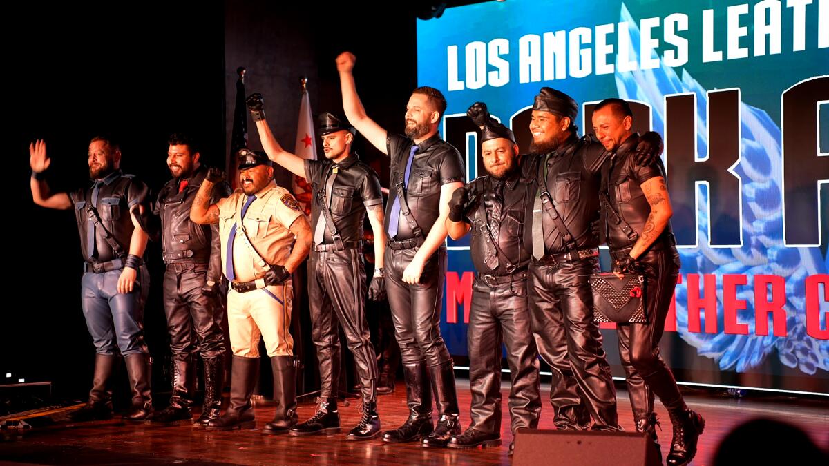 Men in head-to-toe leather on stage. 