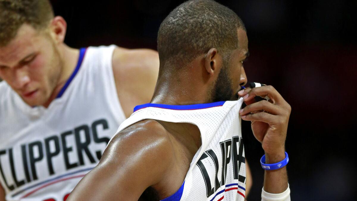 Clippers point guard Chris Paul and Blake Griffin react as they fall behind the Jass by 15 points in the fourth quarter Wednesday night.