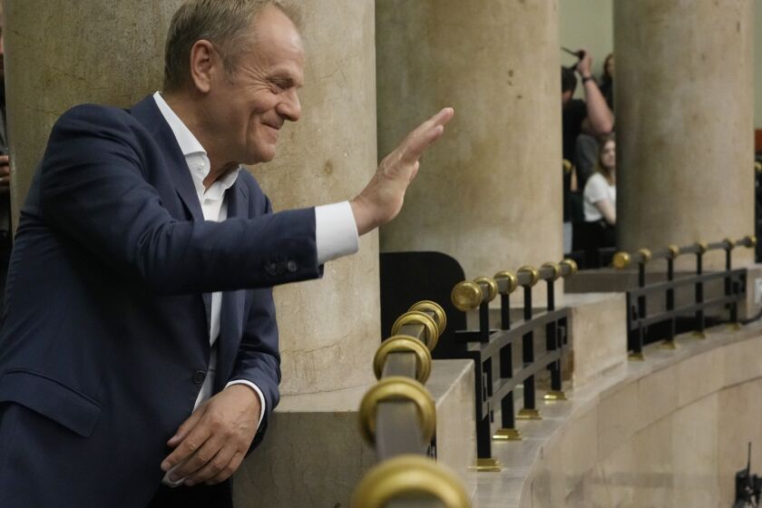 Poland's opposition leader and former prime minister, Donald Tusk, watches lawmakers vote to approve a contentious draft law in parliament in Warsaw, Poland, on Friday, May 26, 2023. The law is for investigating Russia's alleged influence in Poland that is targeting the opposition, especially Tusk, and may affect the outcome of fall parliamentary elections. (AP Photo/Czarek Sokolowski)