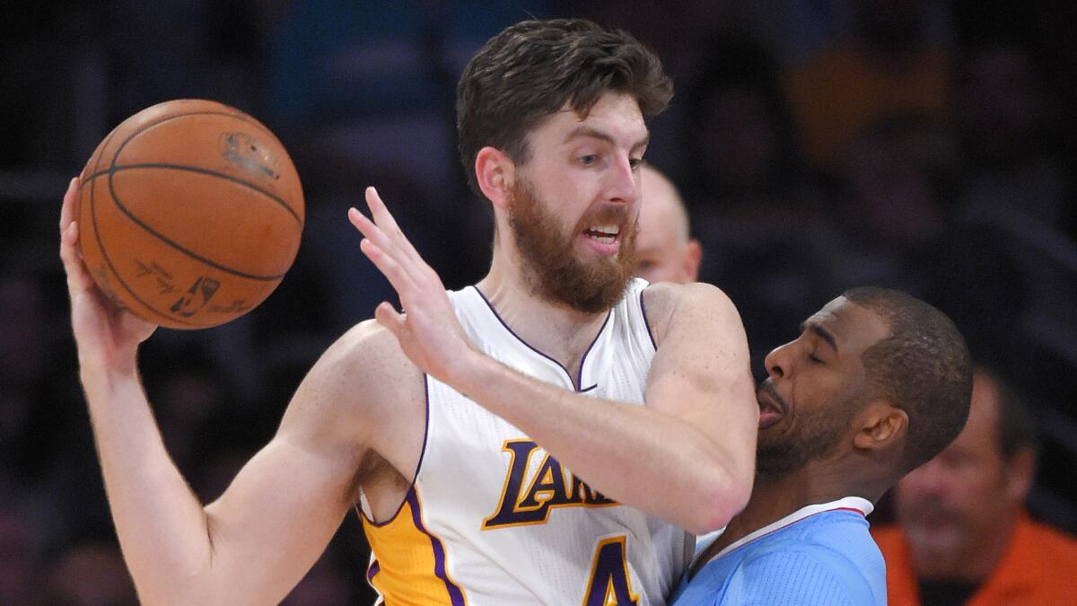 Lakers forward Ryan Kelly, left, makes contact with Clippers point guard Chris Paul during a loss to the Clippers at Staples Center on April 5.