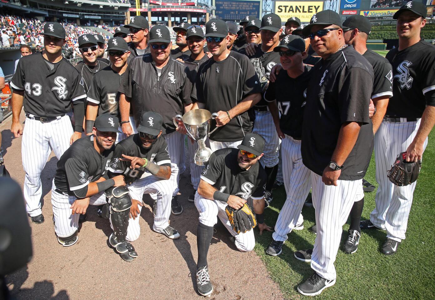 The White Sox hold the Crosstown Cup after their victory.