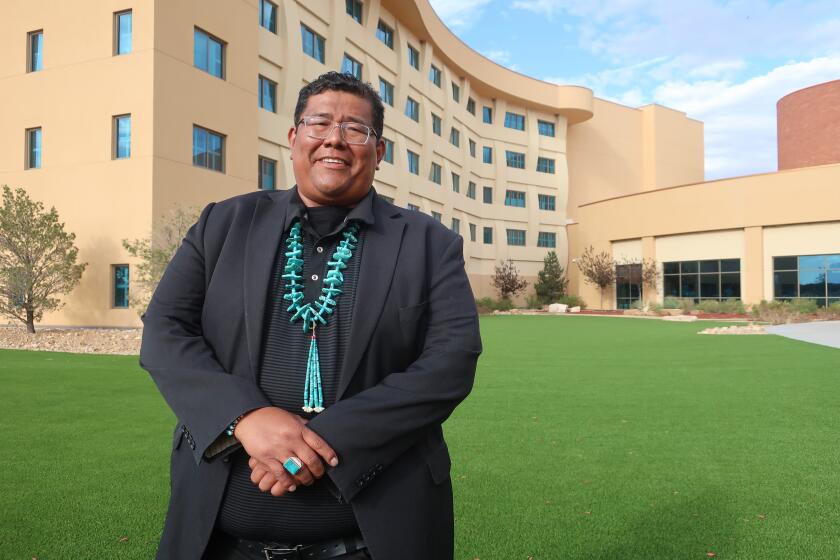 FILE - Dineh Benally poses for a photograph before a Navajo Nation presidential forum at a tribal casino outside Flagstaff, Ariz., Tuesday, June 21, 2022. Chinese workers allege they were lured to northern New Mexico under false pretenses and forced to work 14 hours a day trimming marijuana on the Navajo Nation where cultivating the plant is illegal, according to a lawsuit filed Wednesday, Sept. 27, 2023, in state court. The lawsuit names as defendants Navajo businessman Benally and Taiwanese entrepreneur Irving Lin, who was arrested in 2022 following a raid in California. (AP Photo/Felicia Fonseca, File)