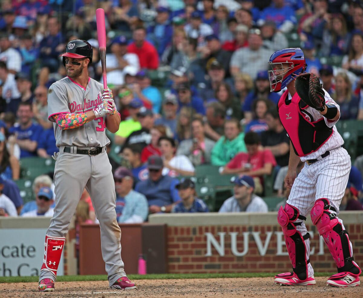 Washington's Bryce Harper is intentionally walked in the 12th inning as the Chicago Cubs' David Ross waits for the pitch.