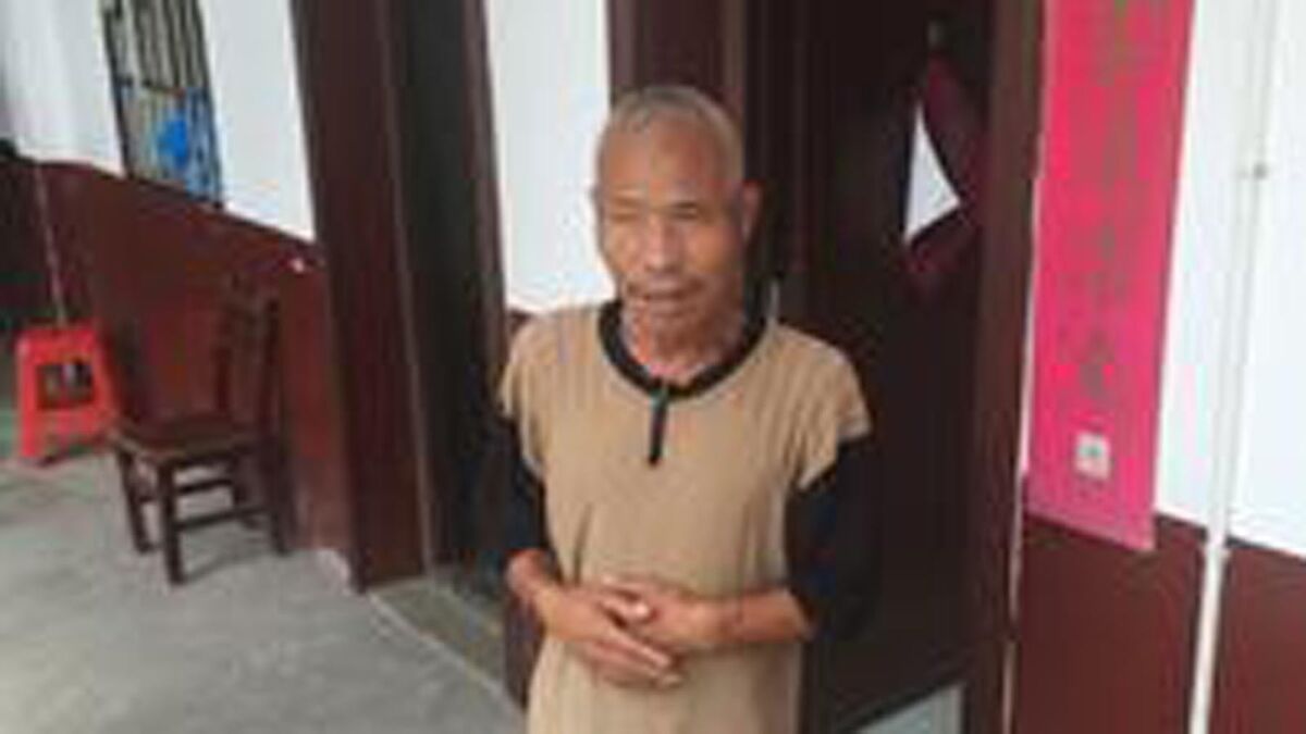 Ma Jixiang stands outside his room at the Baishi Town Central Elderly Home in Hunan province, China.