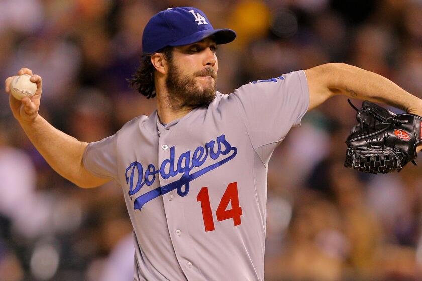 Dodgers starter Dan Haren delivers a pitch during the third inning of a 10-4 loss to the Colorado Rockies on Sept. 16.
