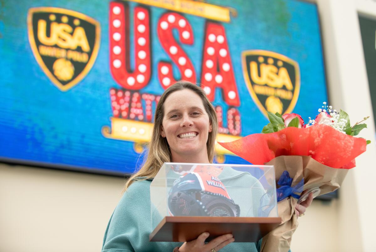 Gold medalist Alys Williams holds a cap and flowers at Long Beach City College on Monday.