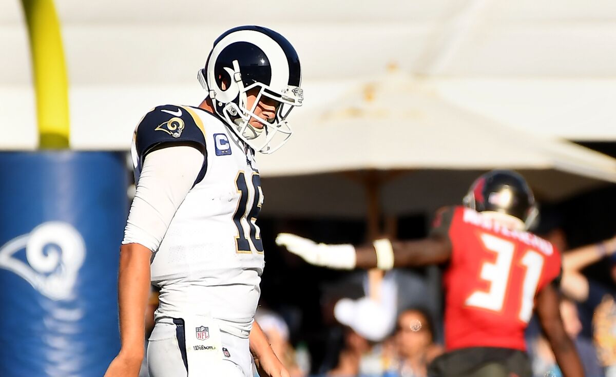 Jared Goff walks off the field after fumbling the ball late in the fourth quarter.