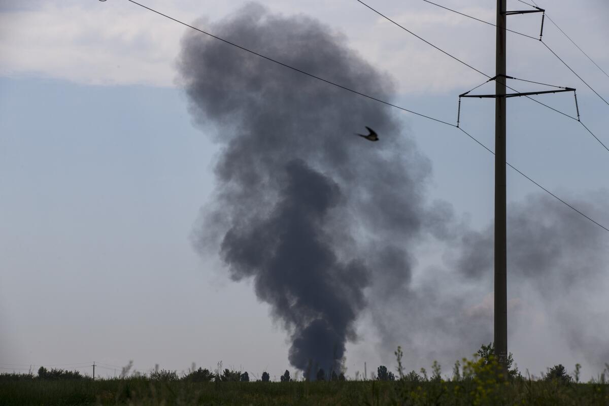 Smoke billows from a Ukrainian helicopter shot down May 29 near Slovyansk, in eastern Ukraine, by pro-Russia gunmen. Twelve Ukrainian soldiers died in the crash, including a general.