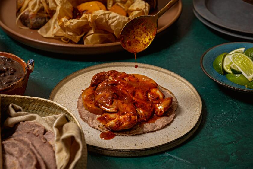 LONG BEACH, CA - OCTOBER 4: Drizzling sauce onto the Mixiote and fresh hand-made tortillas on Friday October 4, 2024 in Long Beach, CA. (Ron De Angelis / For The Times)