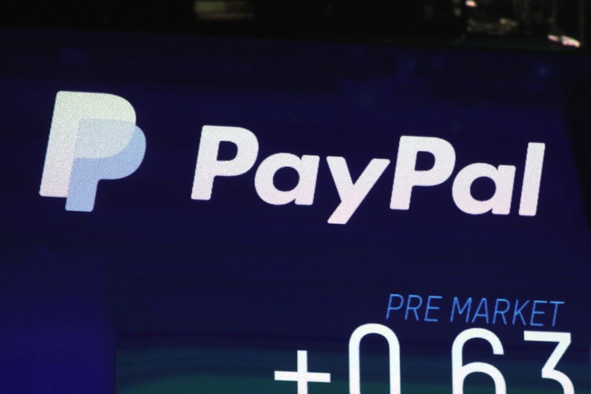 FILE - In this Oct. 3, 2018, file photo the PayPal logo appears on a screen at the Nasdaq MarketSite, in New York's Times Square. PayPal says that its users will now be able to send money to Ukrainians, both in the war-ravaged country as well as those who are now refugees across Europe, Thursday, March 17, 2022. (AP Photo/Richard Drew, File)
