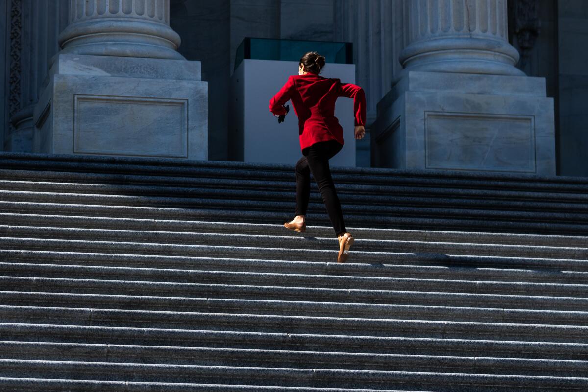 Rep. Alexandria Ocasio-Cortez sprints up the Capitol's steps in a red blazer and short heels. 