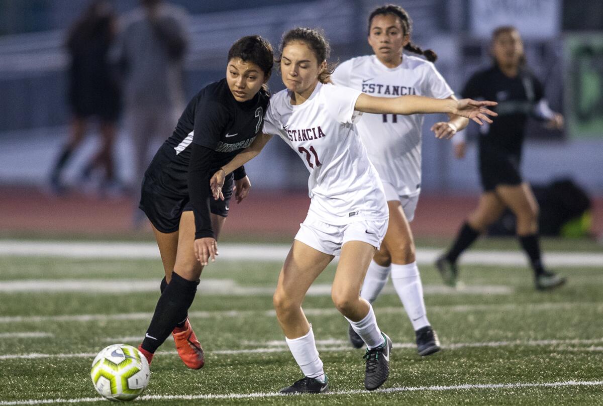 Costa Mesa's Itzel Ramirez, left, and Estancia's Elly Goan battle for a ball during an Orange Coast League match on Tuesday.