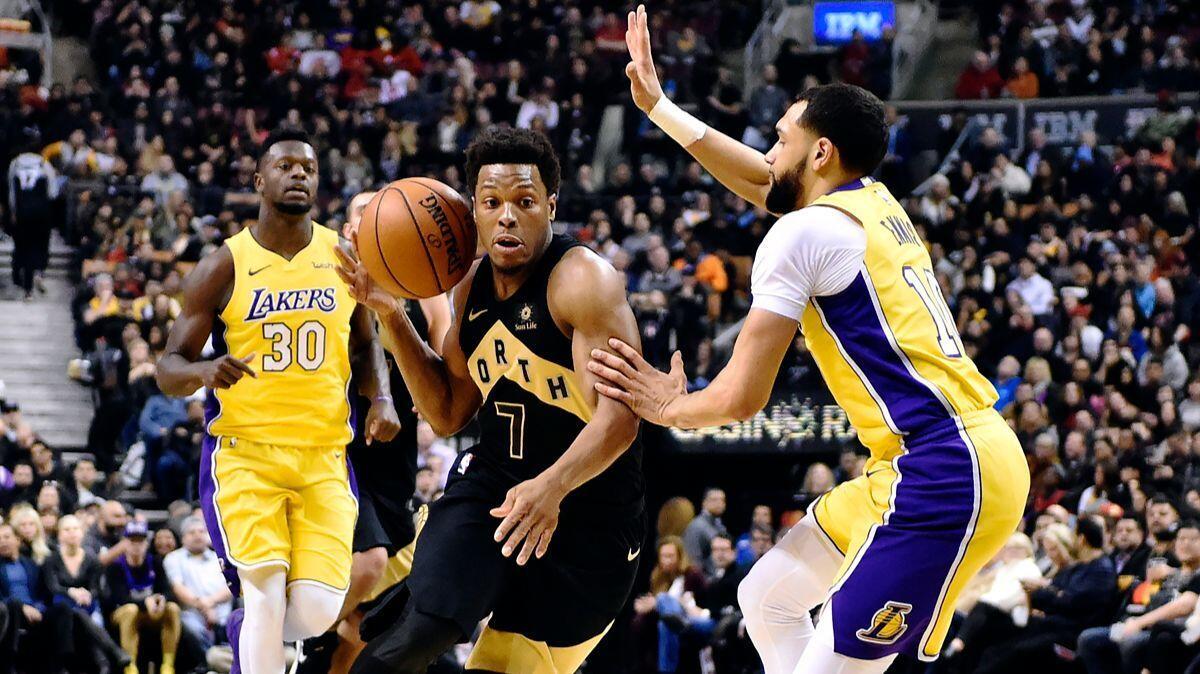 Raptors point guard Kyle Lowry goes for 14 points and 11 rebounds against Tyler Ennis and the Lakers on Sunday in Toronto.
