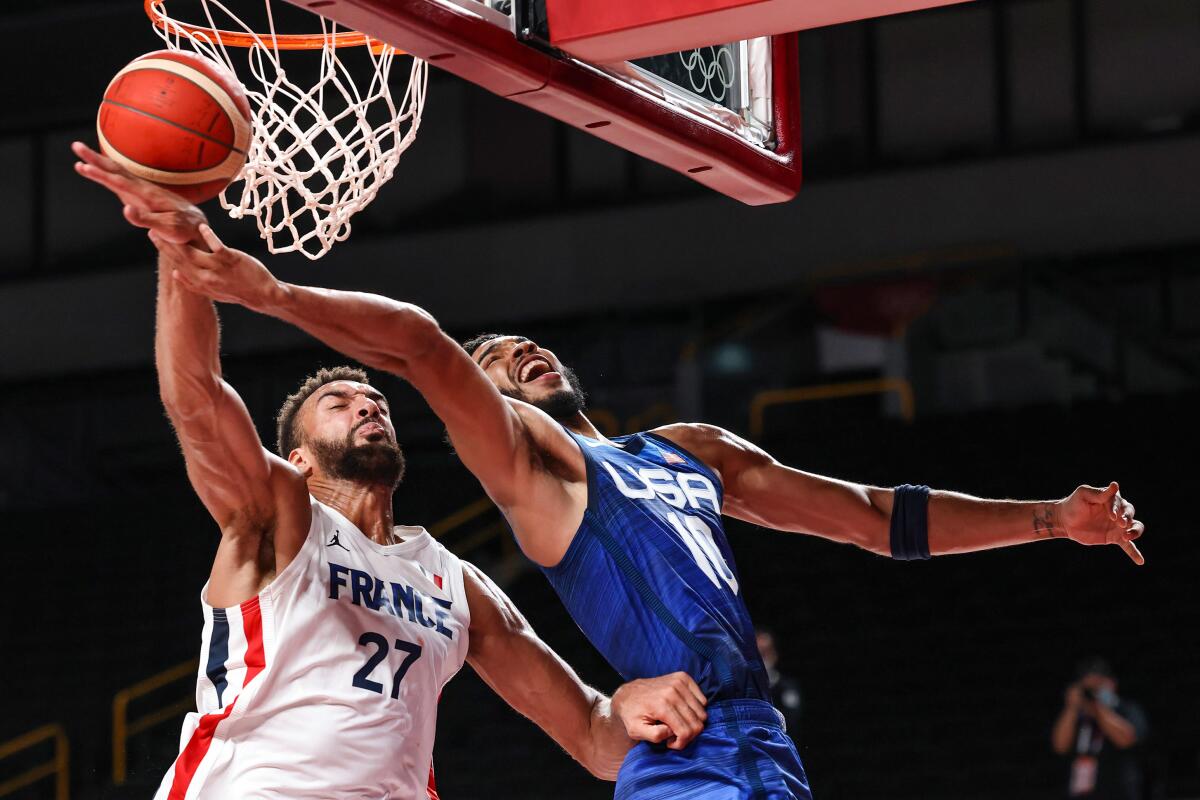 U.S. forward Jayson Tatum is fouled by France center Rudy Gobert.