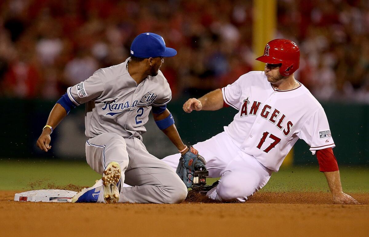 Angels catcher Chris Iannetta slides past Royals shortstop Alcides Escobar in the eighth inning of Game 1 of the American League division series.
