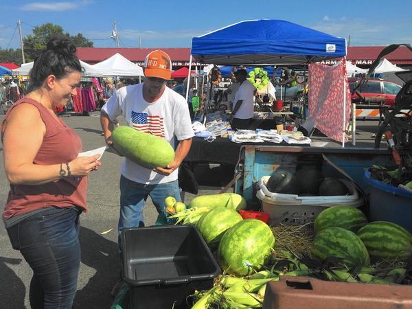 Chef Sara Bradley shops for melons at the Paducah farmers market that takes place downtown on Saturdays.