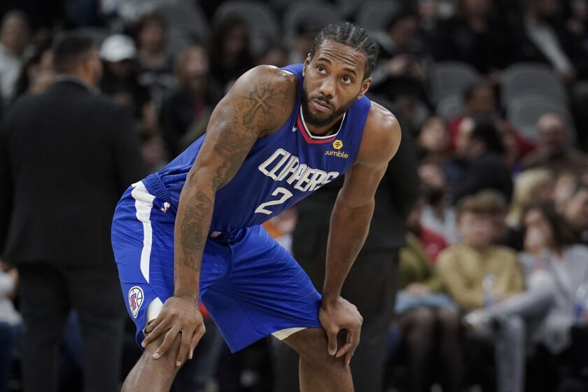 Los Angeles Clippers' Kawhi Leonard pauses on the court during the first half of an NBA basketball game.