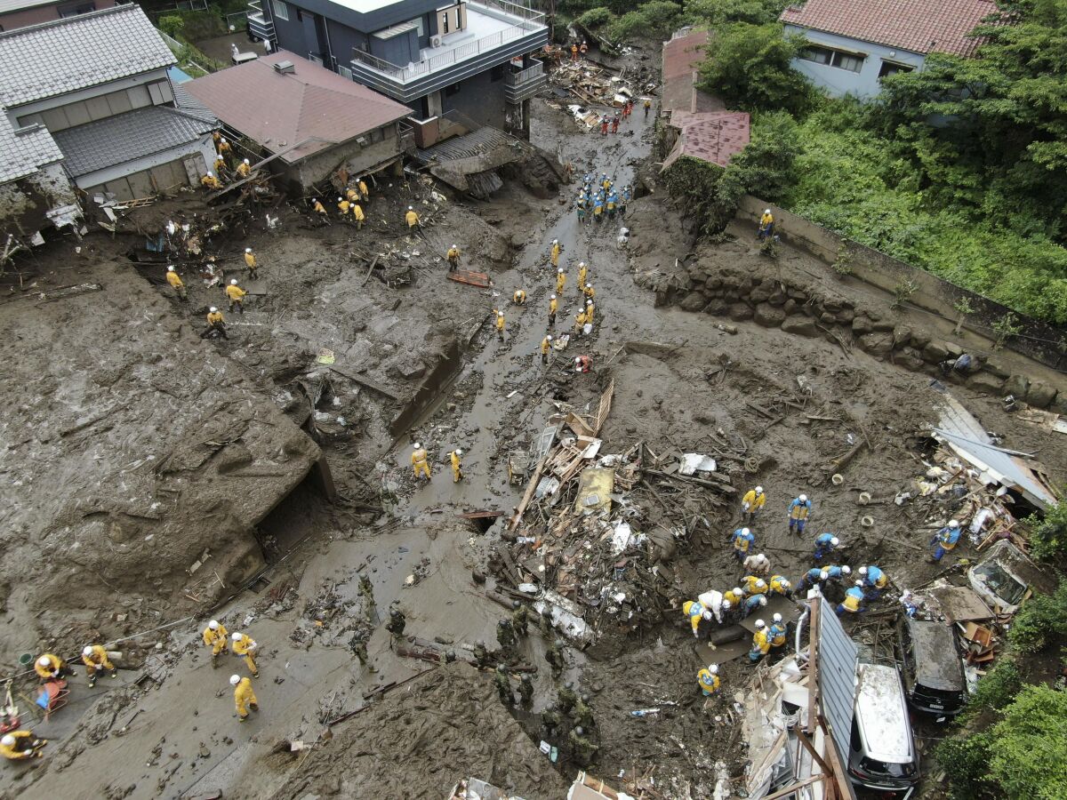 Rescuers continue a search operation at the site of a mudslide at Izusan in Atami, Shizuoka prefecture, southwest of Tokyo Tuesday, July 6, 2021.(Koji Harada/Kyodo News via AP)
