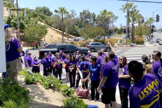 Dodger Stadium game-day workers take part in a protest on Vin Scully Avenue outside Dodger Stadium.