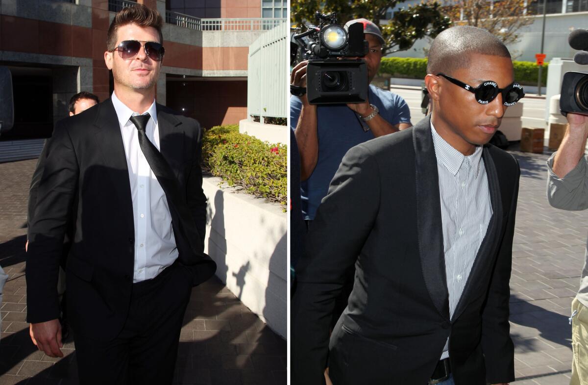 Musicians Robin Thicke, left, and Pharrell Williams are seen outside the federal courthouse in Los Angeles on March 5.