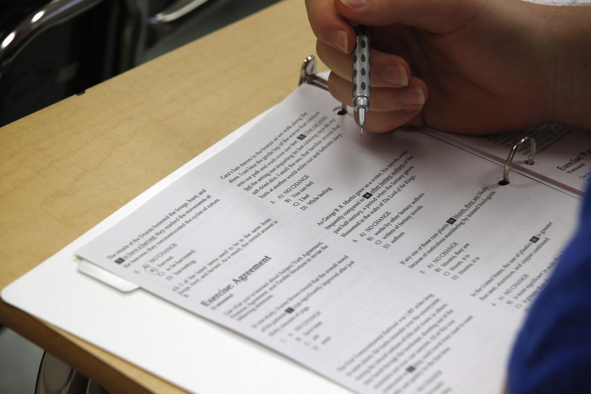 A student looks at questions during a college test preparation class. 