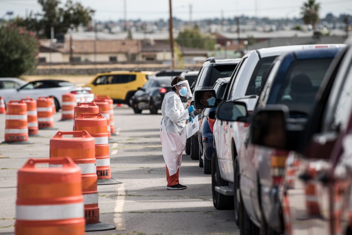 An attendant talks to a motorist at a coronavirus testing site at Ascarate Park in El Paso. 