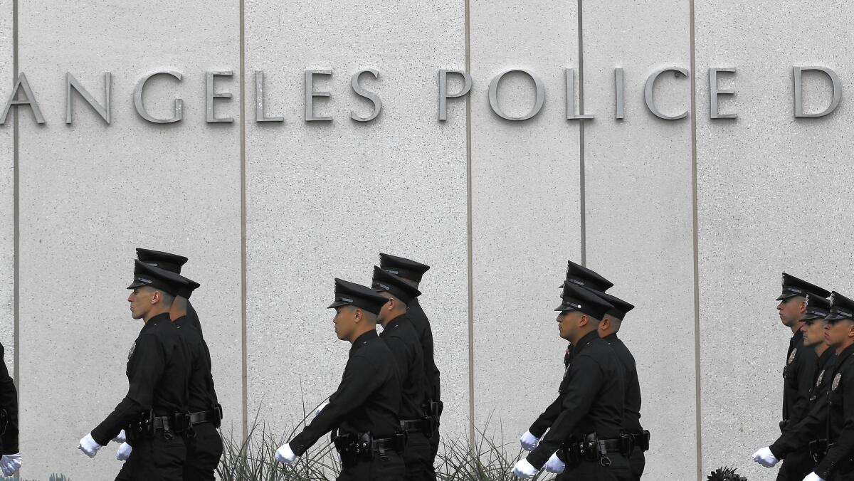 LAPD officers march in front of the station