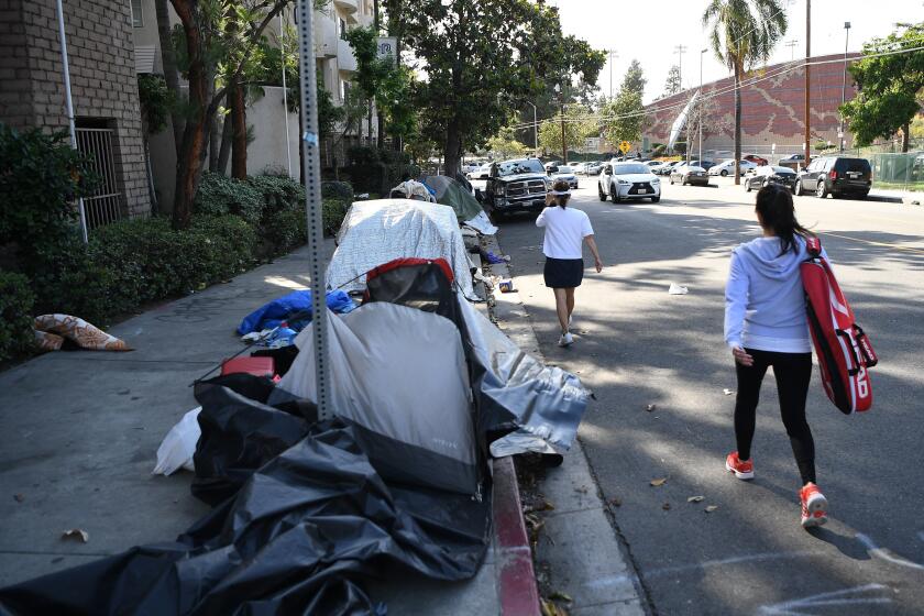 Tents line a sidewalk in Los Angeles.