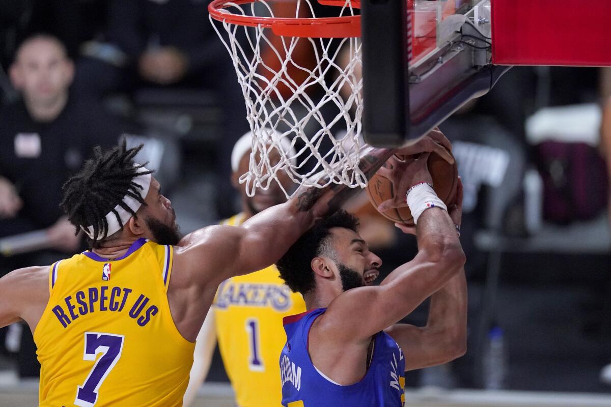Lakers center JaVale McGee blocks a shot Nuggets guard Jam byal Murray during Game 1.