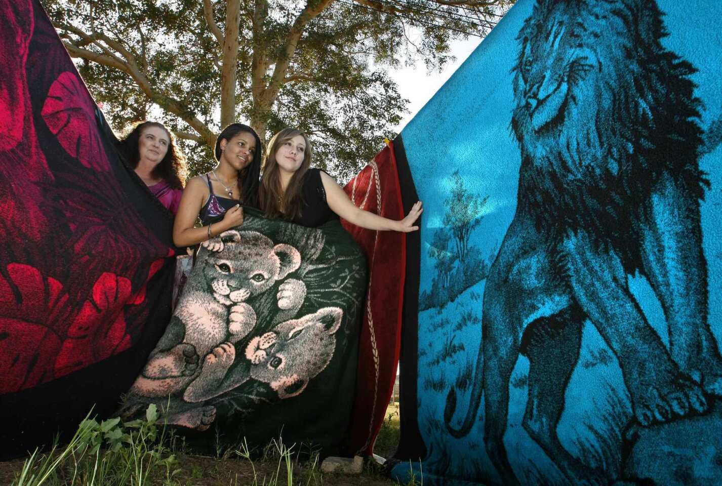 Paula Valenzuela, left, ended up accumulating almost 400 San Marcos blankets. The El Centro resident and her teenage daughters, Elizabeth, middle, and Mariana, show a few left from Valenzuela's collection. She sold the rest on line after her husband threatened to call the "Hoarders" television show.