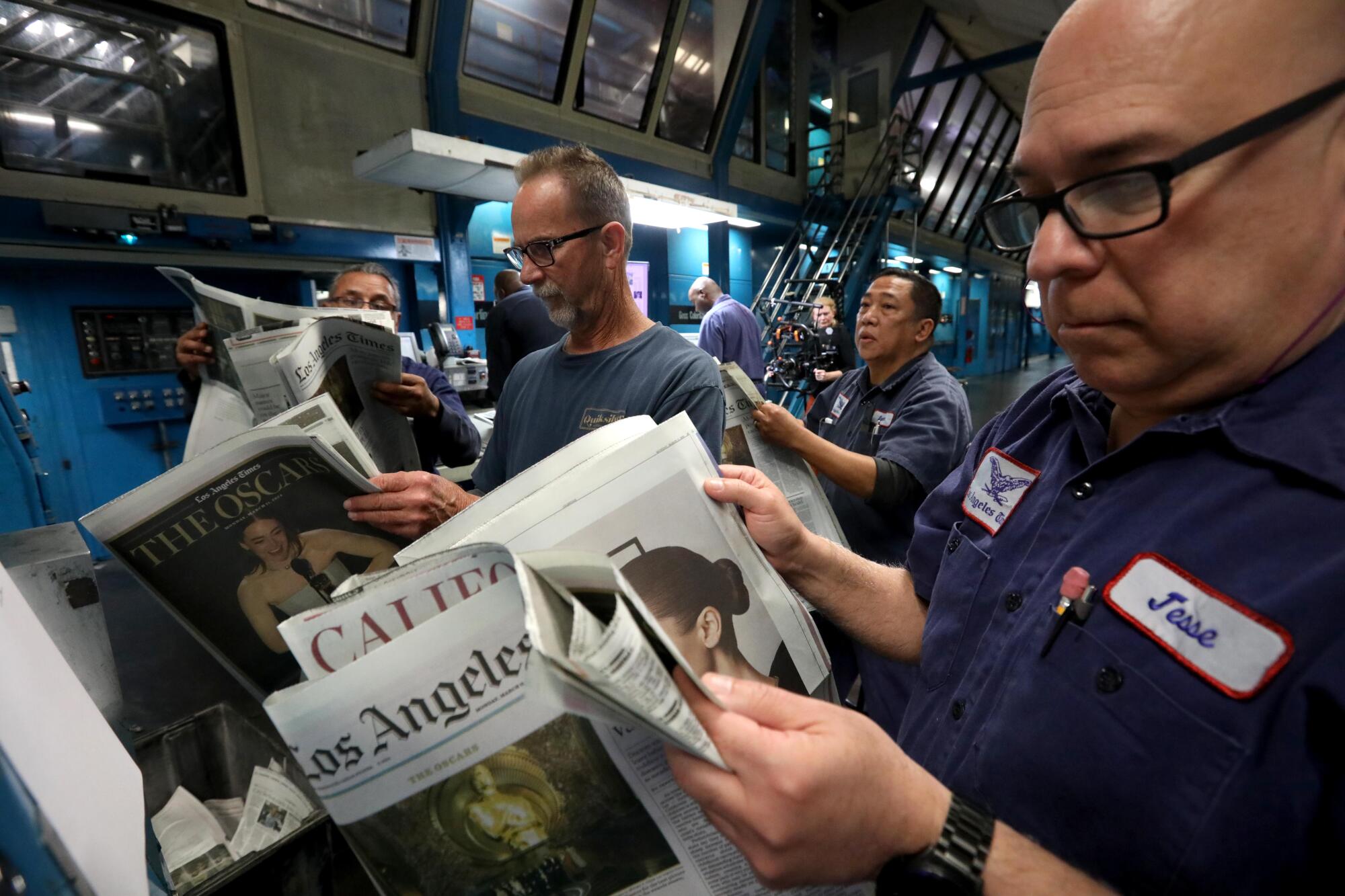 Pressmen check the pages of the Los Angeles Times for corrections.